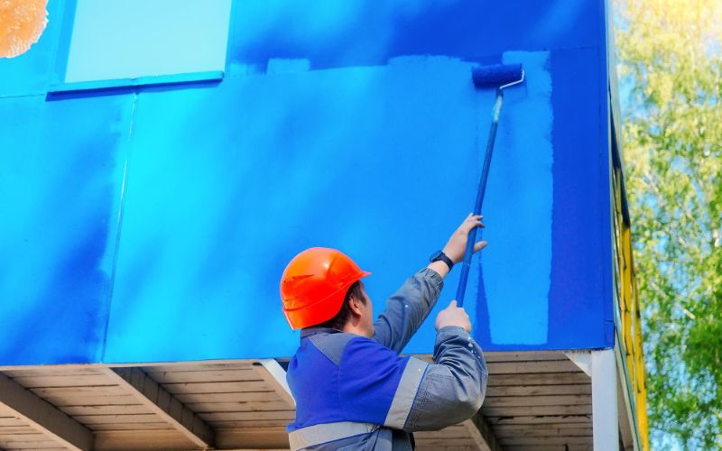 Exterior home painting: A house with freshly painted walls in a vibrant color, enhancing its curb appeal.