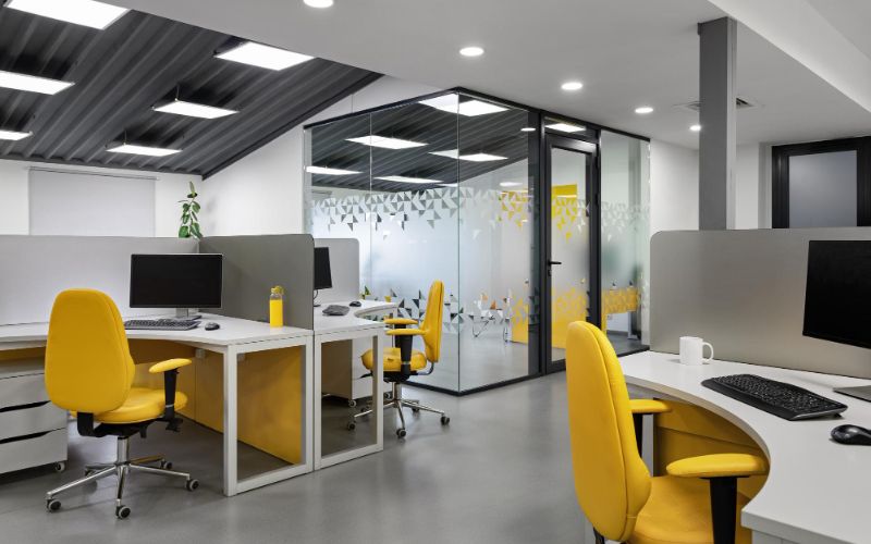 bright yellow it office interior design with glass wall with workplaces employees productivity